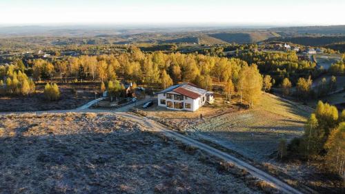an aerial view of a small house on a hill at Domeniul H in Rişca