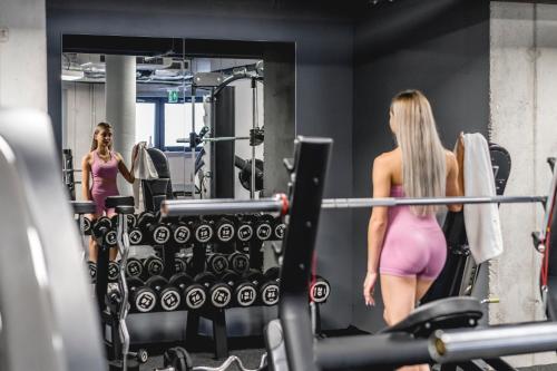 two women in a gym looking in a mirror at Aura Medical SPA Nałęczów in Nałęczów