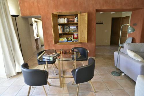 a living room with a glass table and chairs at La Chalentine in Chevreaux