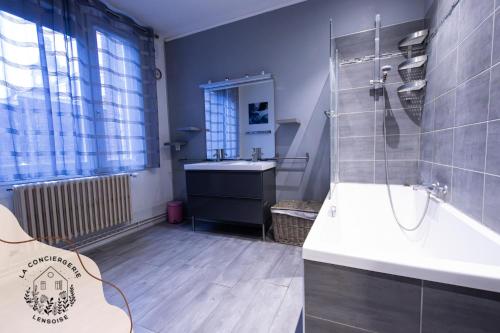 a bathroom with a sink and a shower at Ohana, appartement de charme, au centre de Lens in Lens