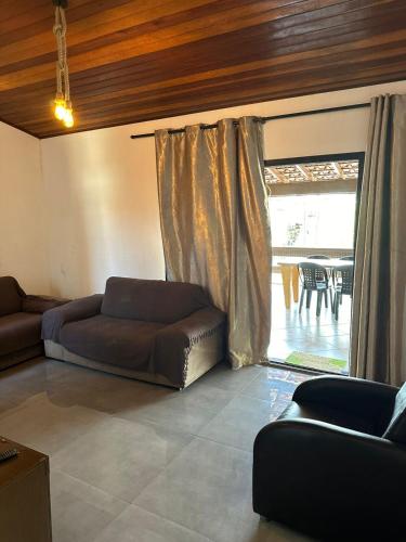 a living room with a couch and a window at Casa Al Mare in Itanhaém