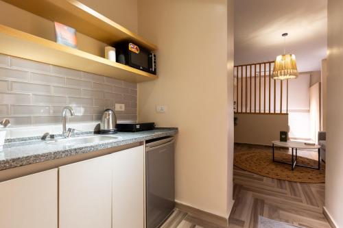 a kitchen with a sink and a counter top at BIRD NEST Near Arkan Plaza in Cairo