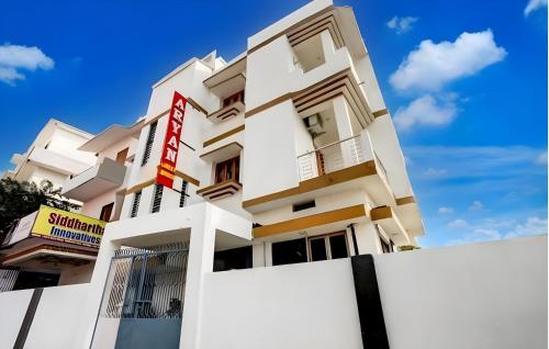 a white building with a sign on it at Aryan guest house in Bodh Gaya