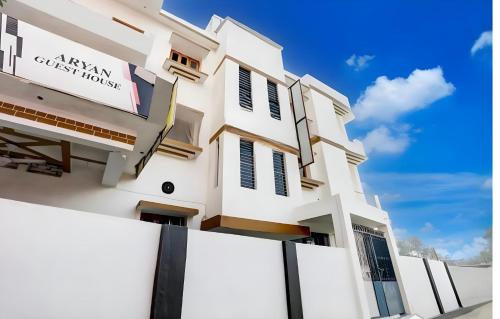 a white building with a sign on it at Aryan guest house in Bodh Gaya