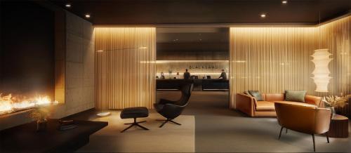 a living room with a couch and a chair at Black Sand Hotel in Ölfus