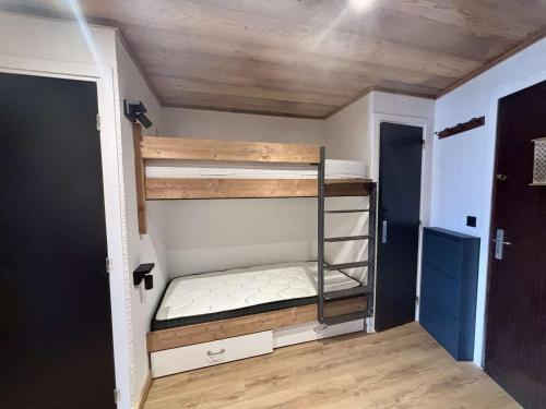une chambre avec deux lits superposés dans une pièce dans l'établissement Studio pour 6 à L'Alpe d'Huez, proche pistes, casier à skis - FR-1-405-363, à Huez