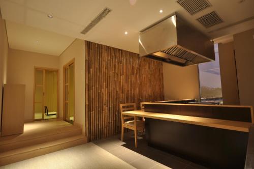 a kitchen with a counter and a stove top oven at GTV Hotel in Cikarang