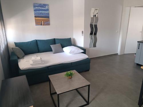 a living room with a couch and a table at Royal place in Nin