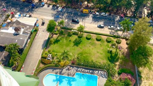 an aerial view of a garden with a swimming pool at VIP 375 large studio, ocean view in Rayong
