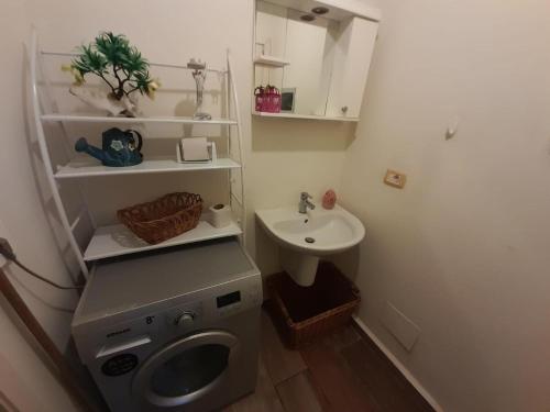 a small bathroom with a toilet and a sink at Batrouna Park resort Generator is included pool in Batroûn