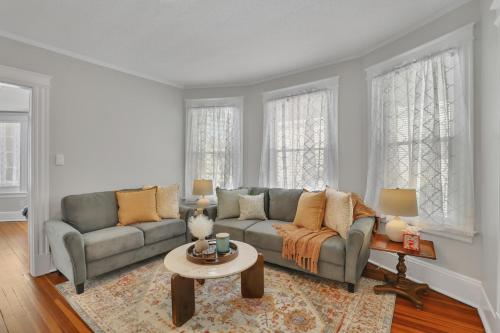 a living room with a couch and a table at West Hartford Center- Charming New England Apt in West Hartford