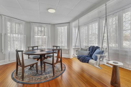 a dining room with a table and chairs and a couch at West Hartford Center- Charming New England Apt in West Hartford