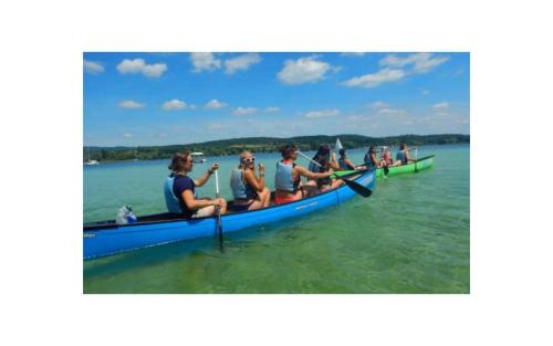 a group of people in a canoe on the water at Joos Boardinghouse in Radolfzell am Bodensee