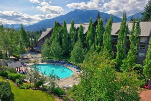 an aerial view of a resort with a swimming pool at The Aspens 2BR, Upper Village, Sleeps 5, Pool, Hot Tub & Gym in Whistler