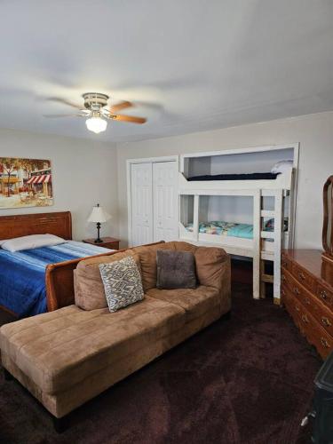 a living room with a couch and a bed at Mins To HospitalsPool Table BBQ Grill HDTV in Fredericksburg