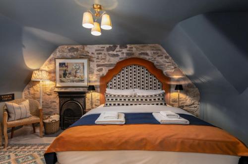 a bedroom with a large bed and a fireplace at The Unique Cathedral Hideaway in Stirling