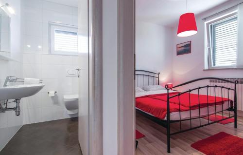 a bedroom with a bed and a bathroom with a sink at Casa Fiori in Fiorini