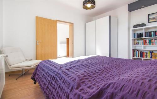 a bedroom with a purple bed and a chair at Casa Fiori in Fiorini
