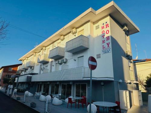 ein Gebäude mit Tischen und Stühlen davor in der Unterkunft hotel roby in Rimini