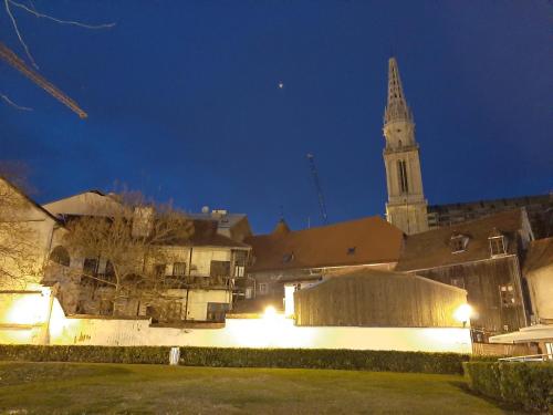a large building with a clock tower at night at Apartment History in Zagreb