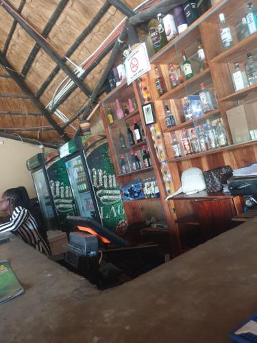 a room with a bar with wooden shelves at Lusaka Backpackers in Lusaka