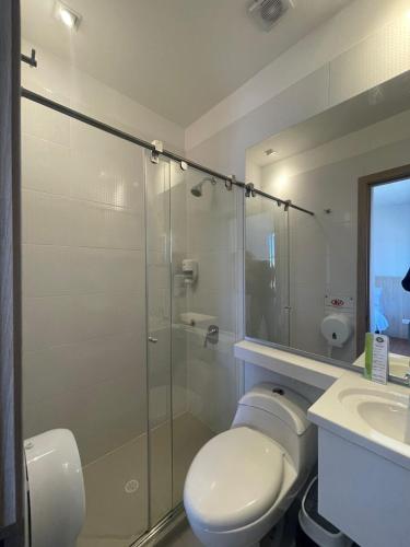 a bathroom with a shower and a toilet and a sink at Casa Hotel Boyaca Real in Bogotá