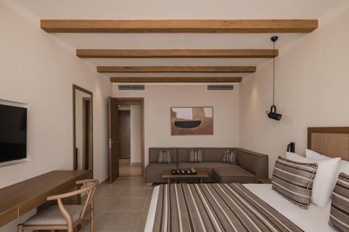 a living room with a bed and a couch at JAZ Elite Riviera in Marsa Alam City