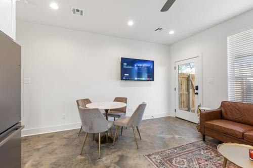 a living room with a table and chairs and a couch at NEW Acadian House KING Bed Cajun Luxury Nespresso in Lafayette