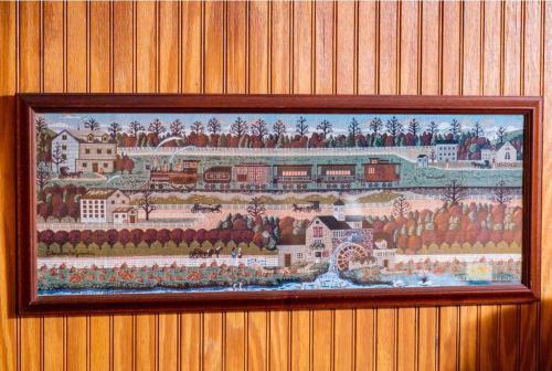 a picture of a painting of a train on a wall at Mountain Aire Cottages, Inn, & Glamping in Clayton