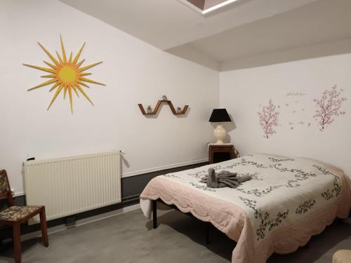 a bedroom with a bed and a clock on the wall at Chambres d'hôtes piscine couverte & chauffée in Bouquemont