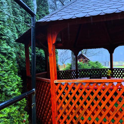 a wooden gazebo with a black roof at Insieme in Vidra