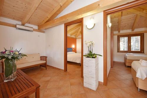 a room with a bedroom with a bed and a mirror at Is Arenas Camping Village in S'archittu Cuglieri