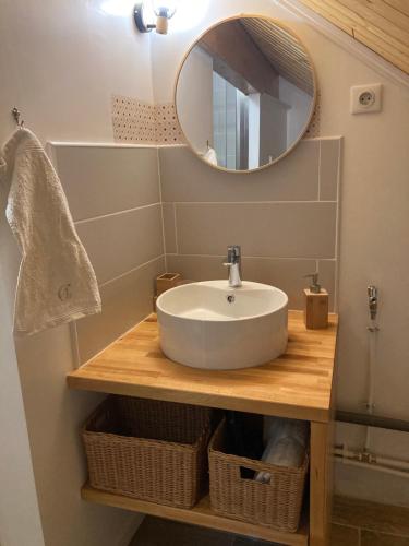 a bathroom with a sink and a mirror at La Chambre du Clos - Meursault in Meursault