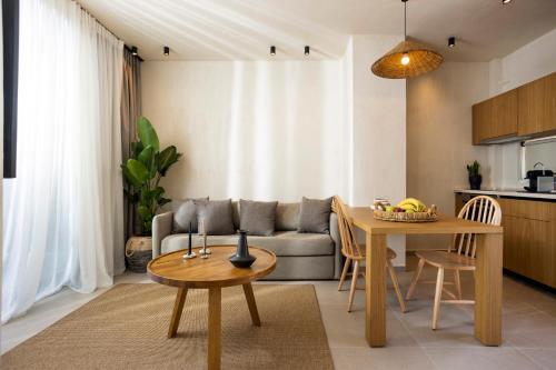 a living room with a couch and a table at Pnoes Luxury Suites in Paliouri