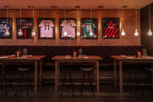 a dining room with tables and signs on the wall at pentahotel Wiesbaden in Wiesbaden