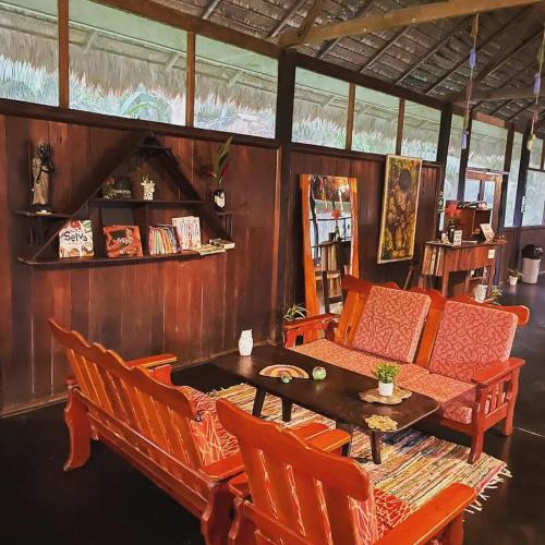 a living room with a table and chairs at Tambopata Haven lodge in Puerto Maldonado