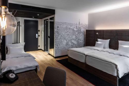 a bedroom with two beds and a wall mural at Pentahotel Rostock in Rostock
