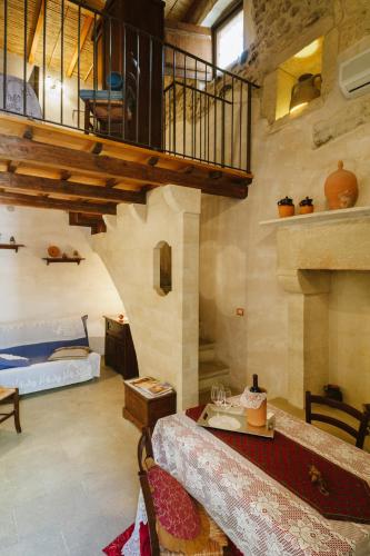 a living room with a table and a staircase at Borgoterra in Martano