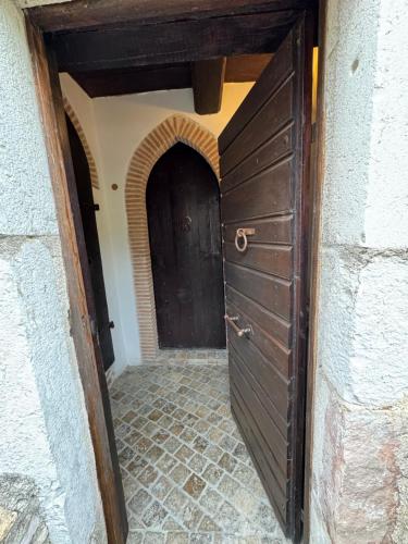 an entrance to a hallway with two doors at Il borgo di Firenzuola Camere con camino in Acquasparta