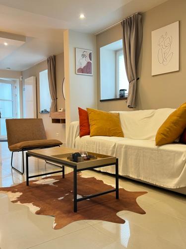 a living room with a couch and a coffee table at Isa'Bellescale - Fully equipped house 2km from Brussels South Airport in Ransart