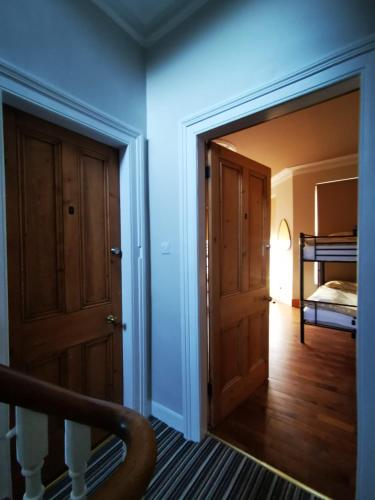 a view of a room with a door and a bedroom at Gr8 Hostel at The Mount in Belfast
