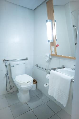 a bathroom with a toilet and a sink at ibis Itu Plaza Shopping in Itu