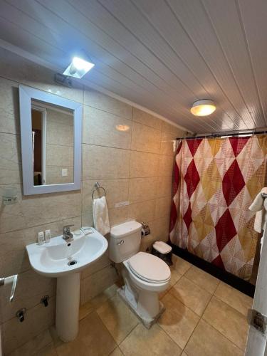 a bathroom with a toilet and a sink at Hotel La Vista 32 in Punta del Este
