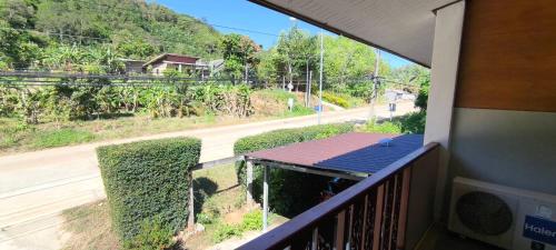 a balcony with a view of a street and a road at JP Place in Ban Ru Yai