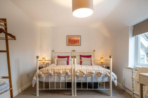 ein Schlafzimmer mit einem Bett mit zwei Kissen in der Unterkunft Mulberries in Adlestrop
