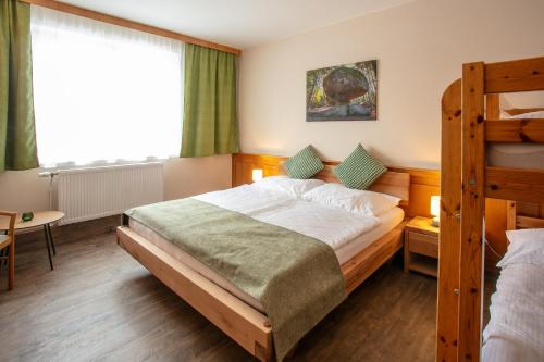 a bedroom with a bed and a bunk bed at Vero Living & more in Hoheneich