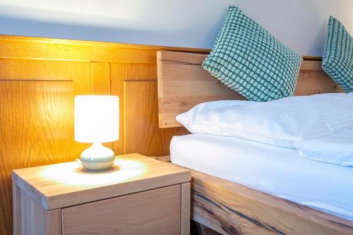 a bedroom with a bed and a lamp on a night stand at Vero Living & more in Hoheneich
