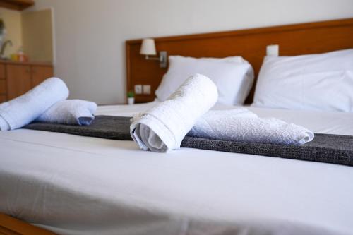 two rolled up towels on top of a bed at Pittas Studios in Kardamaina