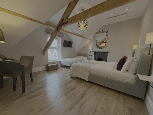 a bedroom with a bed and a desk and a piano at Number One Hundred Bed And Breakfast in Cardiff