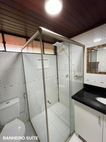 a bathroom with a shower and a toilet and a sink at Refúgio em Barreirinhas Chalé in Barreirinhas